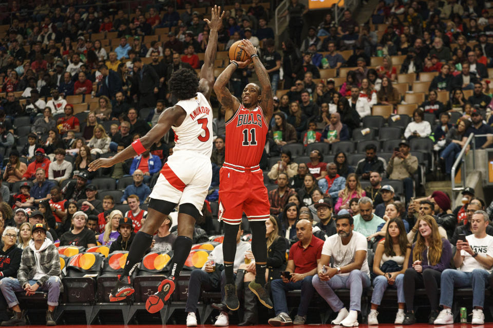 Chicago Bulls guard DeMar DeRozan (11) makes a jump shot over Toronto Raptors forward O.G. Anunoby (3) during the first quarter of an NBA preseason basketball game in Toronto on Sunday, Oct. 9, 2022. (Alex Lupul/The Canadian Press via AP)