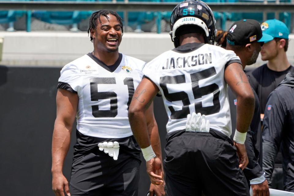 Jaguars rookie linebacker Ventrell Miller (51) jokes with teammate Dequan Jackson (55) during a rookie minicamp practice on May 12.
