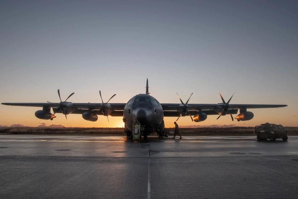 An airman walks toward a grounded military cargo plane