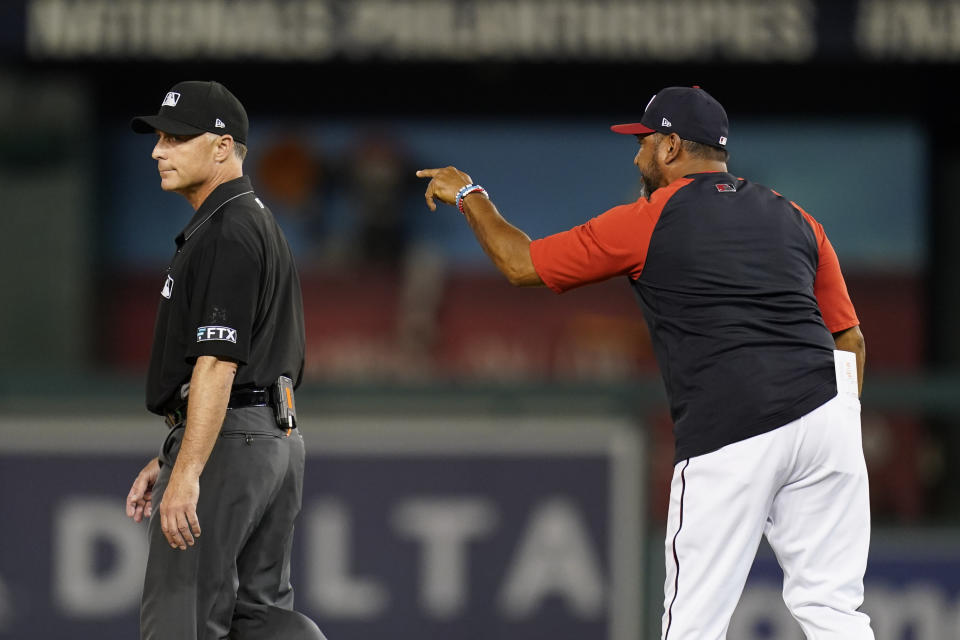 Washington Nationals manager Dave Martinez, right, argues with umpire Dan Iassogna after a play in the 10th inning of the second game of a baseball doubleheader against the Philadelphia Phillies, Friday, June 17, 2022, in Washington. Martinez was ejected after the play. (AP Photo/Patrick Semansky)