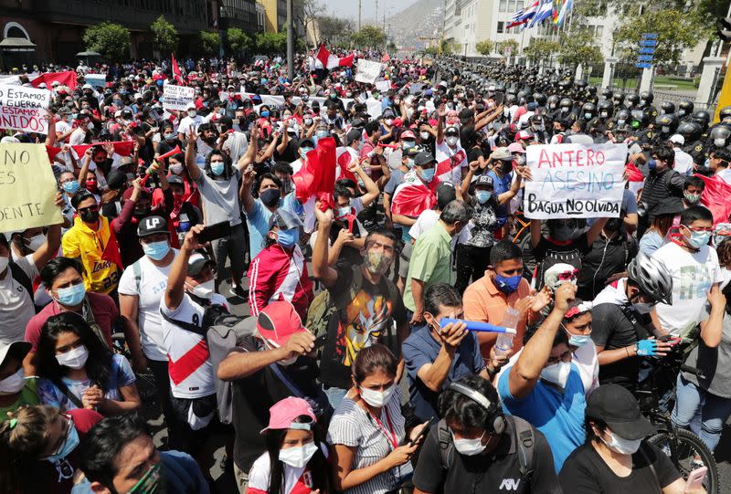 People react after Peru's interim President Manuel Merino announced his resignation, in Lima
