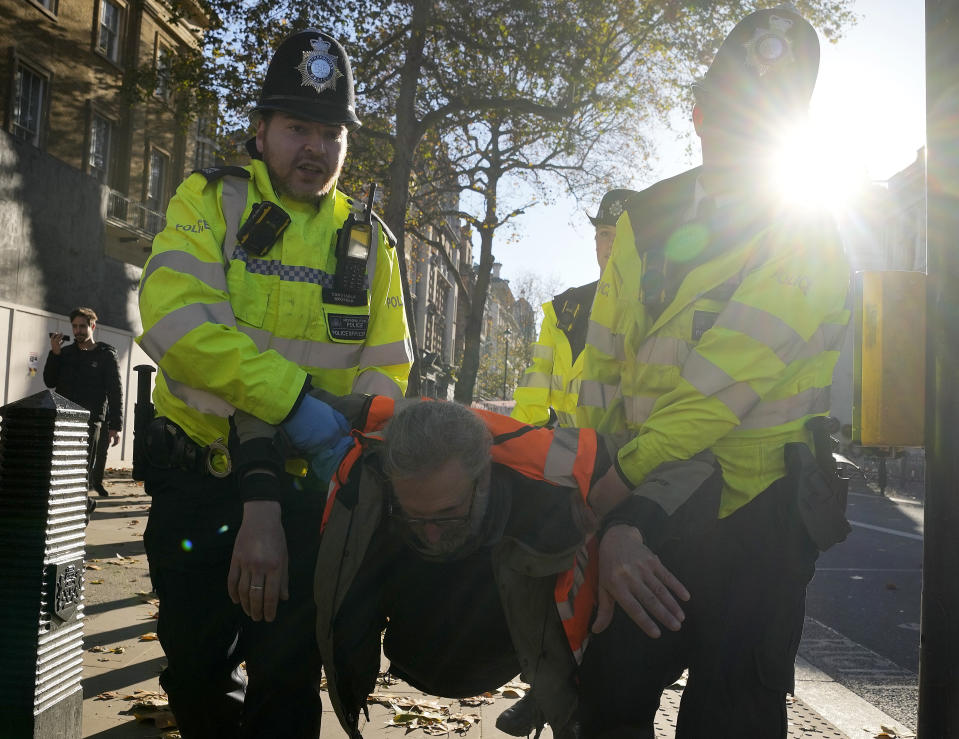Police arrests protesters of the climate campaigners group Just Stop Oil in London, Thursday, Nov. 23, 2023. Britain is one of the world's oldest democracies, but some worry that essential rights and freedoms are under threat. They point to restrictions on protest imposed by the Conservative government that have seen environmental activists jailed peaceful but disruptive actions.(AP Photo/Frank Augstein)