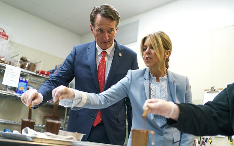 Virginia Gov. Glenn Youngkin (R) and first lady Suzanne Youngkin dip pretzels in chocolate