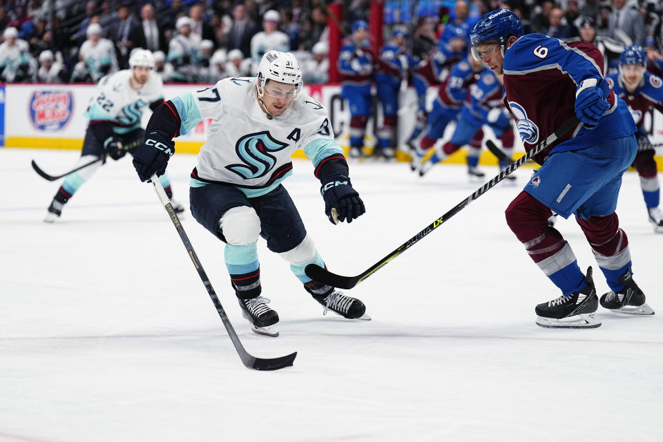 Seattle Kraken center Yanni Gourde (37) skates against Colorado Avalanche defenseman Erik Johnson (6) during the third period of Game 1 of a first-round NHL hockey playoff series Tuesday, April 18, 2023, in Denver. (AP Photo/Jack Dempsey)