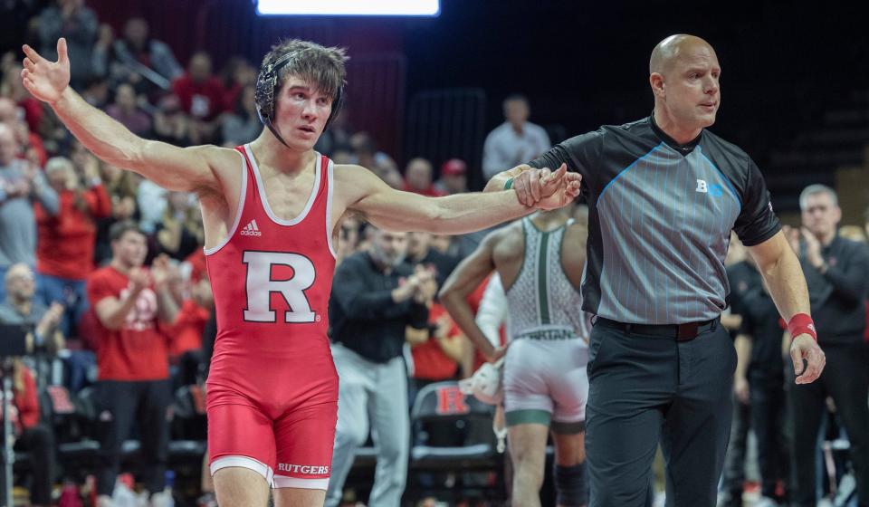 Rutgers' Joe Heilmann gets his hand raised after his 4-3 win over Michigan State's Rayvon Foley Friday night in the 133-pound bout of the Scarlet Knights' 16-15 win.