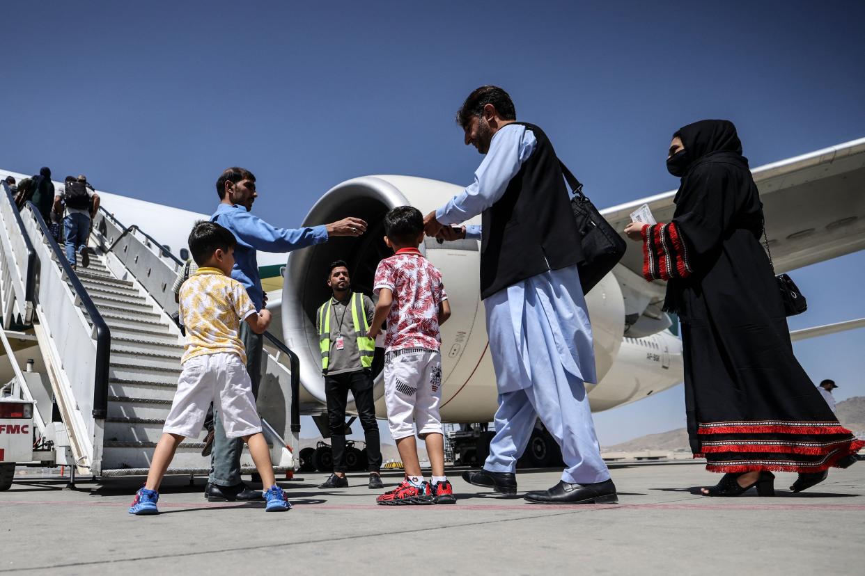 At the airport in Kabul on Sept. 13, passengers wait to board a Pakistan International Airlines plane, the first international commercial flight to land since the Taliban retook power in Afghanistan on Aug. 15. 