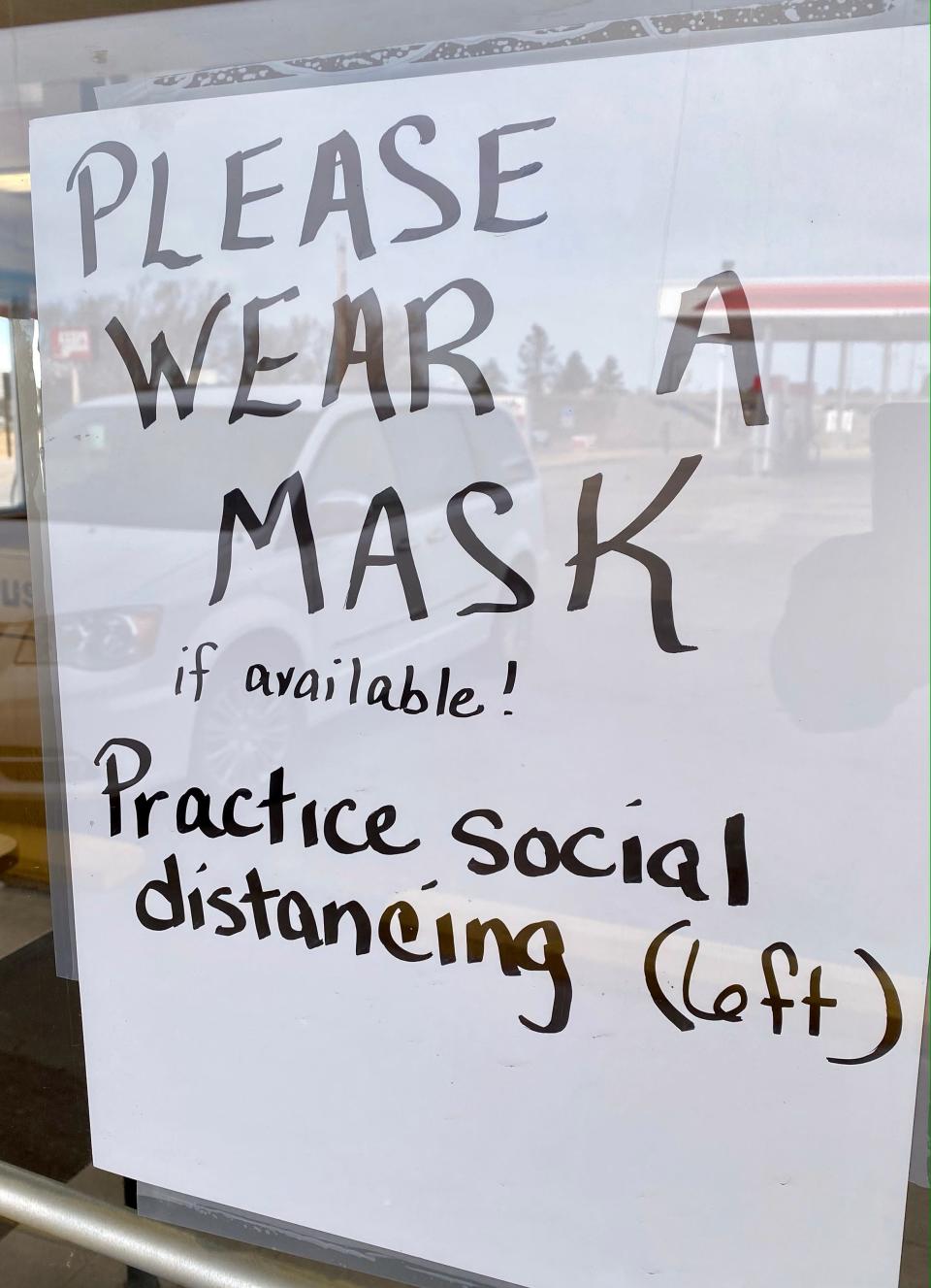 A sign on the Dairy Queen in Quinter, Kansas, asks customers to wear masks if they have them. At the time the photo was taken, the county required masks in public places, but many people ignored the protocol.