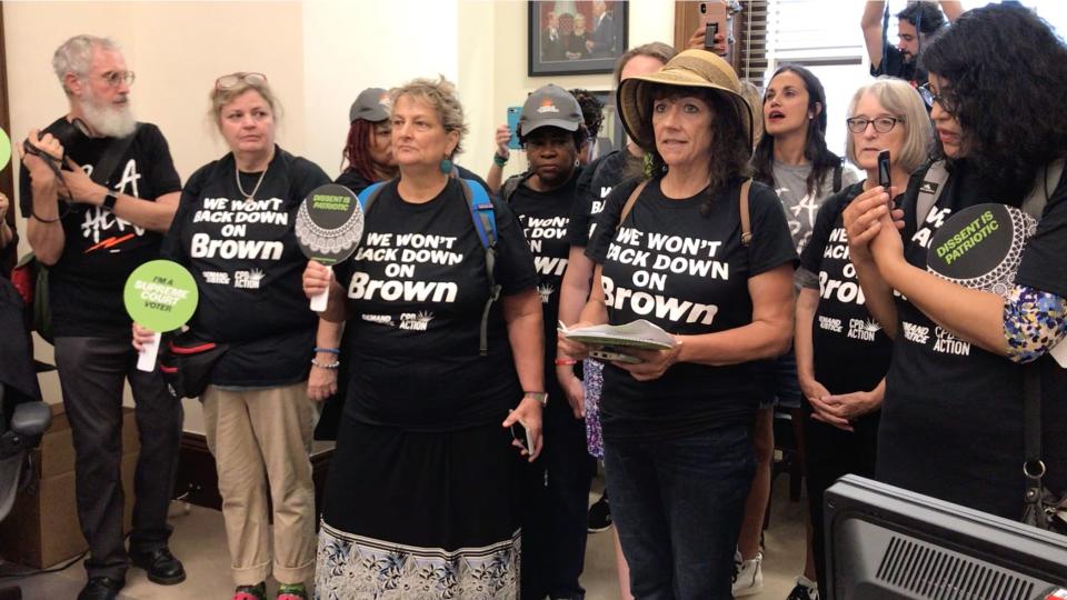 Protesters crashed Sen. Chris Coons' office to urge the Delaware Democrat to stop supporting judicial nominees who won't say if they think Brown v. Board of Education was correctly decided. (Photo: Jen Bendery/HuffPost)