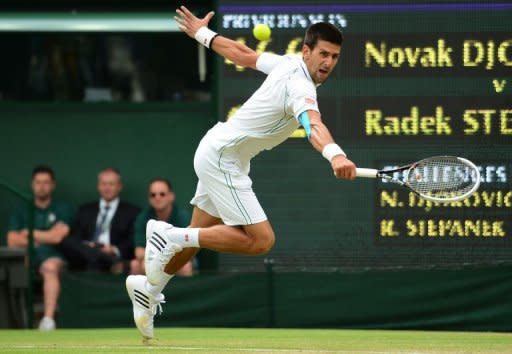 Serbia's Novak Djokovic plays a backhand shot during his third round men's singles victory over Czech Republic's Radek Stepanek on day five of the 2012 Wimbledon Championships tennis tournament at the All England Tennis Club in Wimbledon, southwest London, on June 29, 2012. AFP PHOTO / LEON NEAL RESTRICTED TO EDITORIAL USE