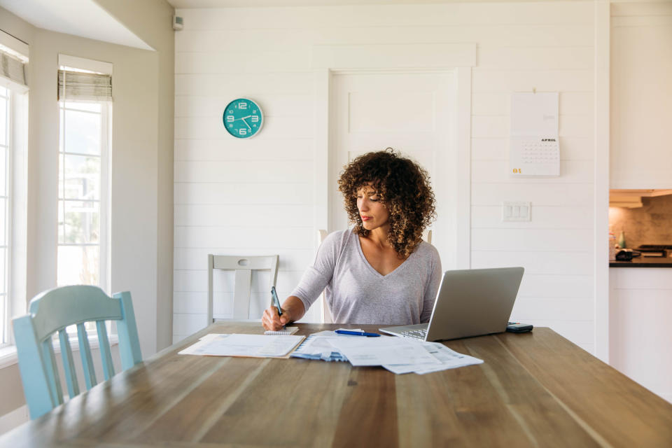 Woman looking at paperwork at home