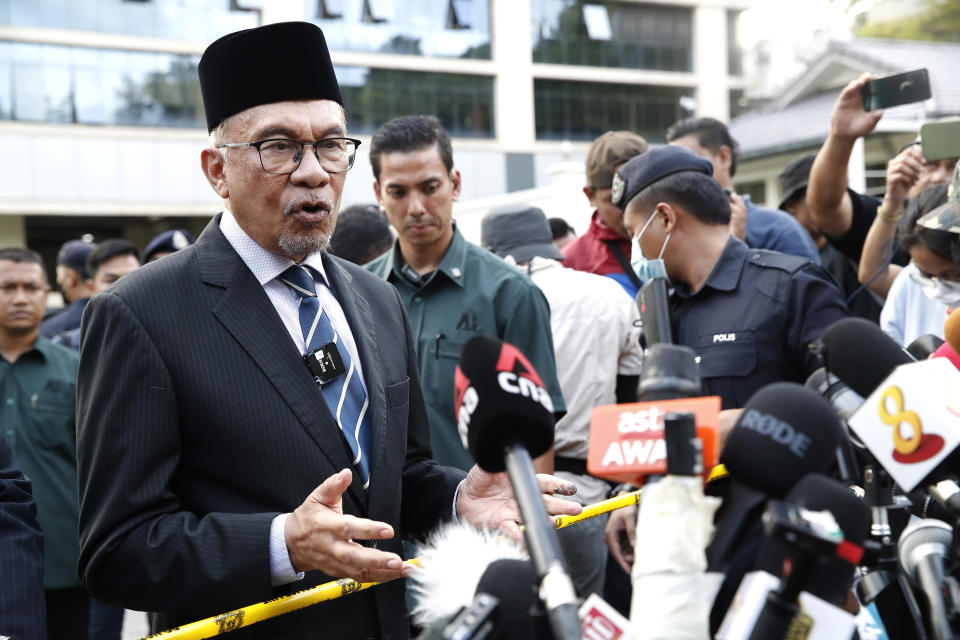 Opposition leader Anwar Ibrahim speaks to media outside the entrance of the National Palace after an audience with the Malaysia's King in Kuala Lumpur, Malaysia, Tuesday, Nov. 22, 2022. Malaysia’s election uncertainty deepened Tuesday after a political bloc refused to support either reformist leader Anwar Ibrahim or rival Malay nationalist Muhyiddin Yassin as prime minister, three days after divisive polls produced no outright winner. (AP Photo/FL Wong)