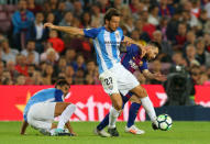 Soccer Football - La Liga Santander - FC Barcelona vs Malaga CF - Camp Nou, Barcelona, Spain - October 21, 2017 Barcelona’s Lionel Messi in action with Malaga's Paul Baysse REUTERS/Albert Gea