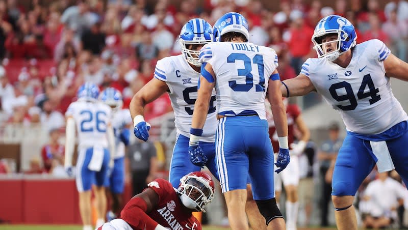 BYU linebacker Max Tooley (31) sacks Arkansas Razorbacks quarterback KJ Jefferson (1) at Razorback Stadium in Fayetteville on Saturday, Sept. 16, 2023.