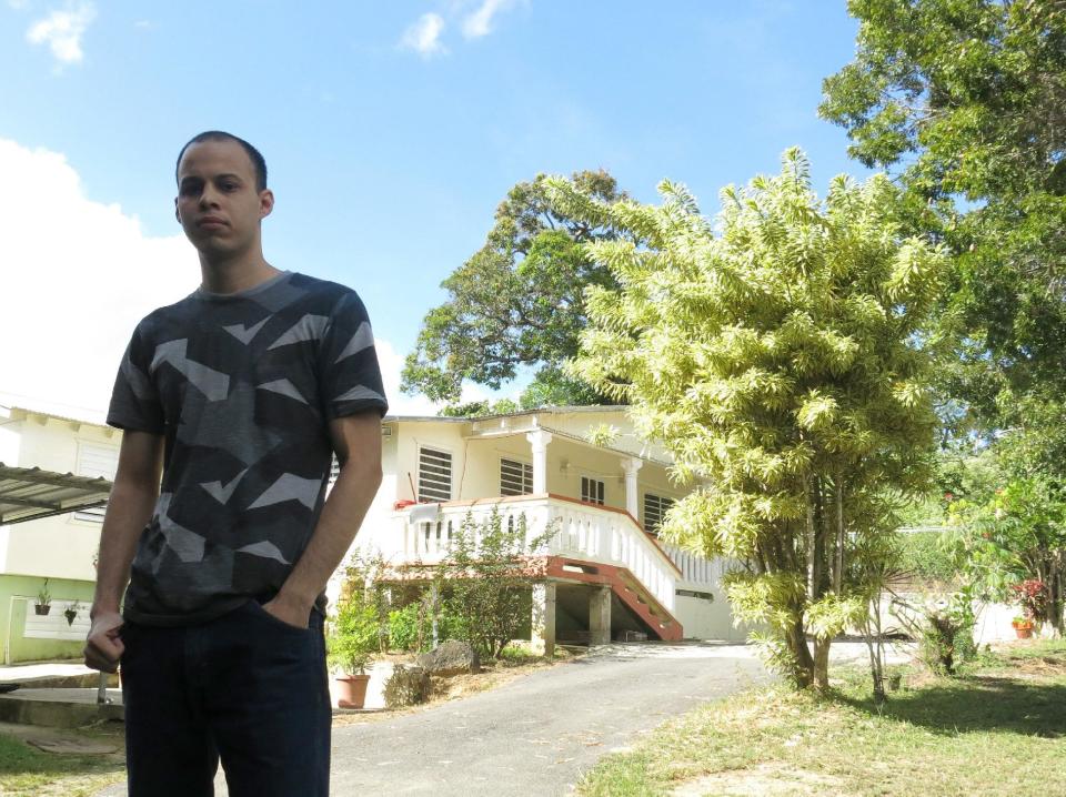 Bryan Santiago poses in front of the family home after speaking about his brother Esteban, a man accused of shooting five people at a Florida airport on Friday, in Penuelas, Puerto Rico, Saturday, Jan. 7, 2017. “The FBI failed there. ... We’re not talking about someone who emerged from anonymity to do something like this,” Bryan Santiago told The Associated Press. “The federal government already knew about this for months, they had been evaluating him for a while, but they didn’t do anything.” (AP Photo/Danica Coto)