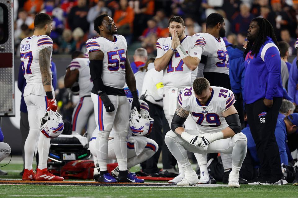 Buffalo Bills players react after teammate Damar Hamlin collapsed on the field during a game against the Cincinnati Bengals.