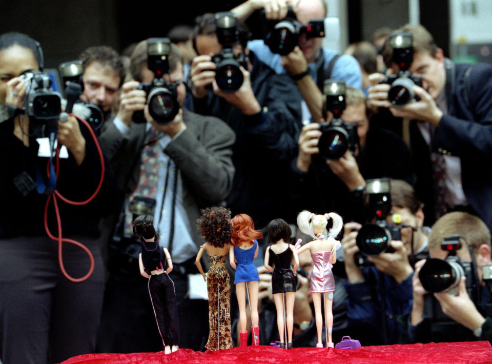 many photographers taking pictures of dolls