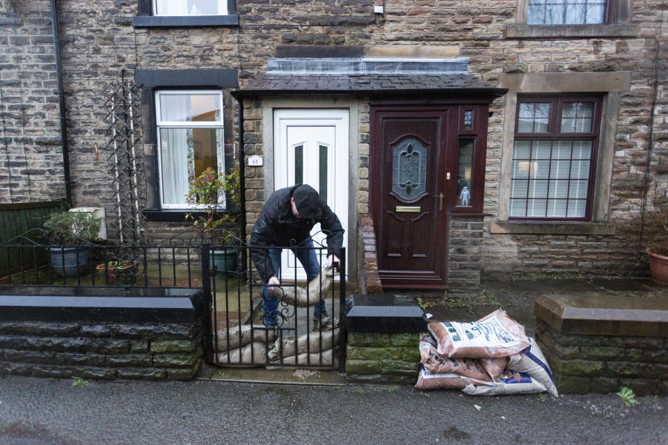 Residents in Littleborough, Greater Manchester, prepare for Storm Christoph as they put sandbags outside their properties.