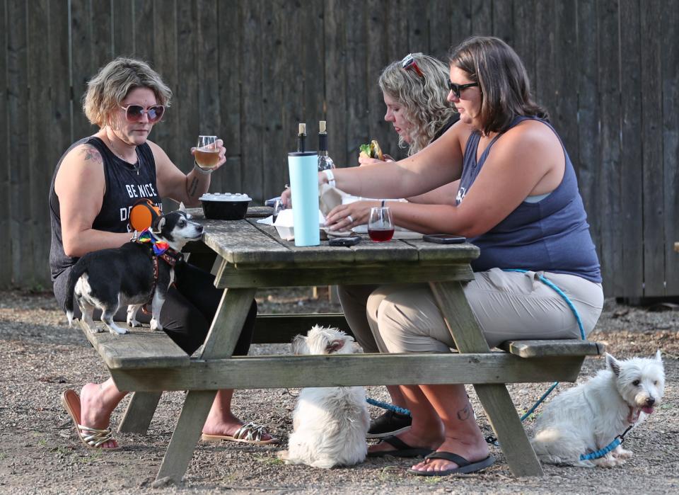 Marisa Caraselli and Loki join with friends Meaghan Arsenault and Torvi and Karen Ramsey and Rosie as they relax during Yappy Hour Tuesdays at The Winery at Wolf Creek in Barberton.