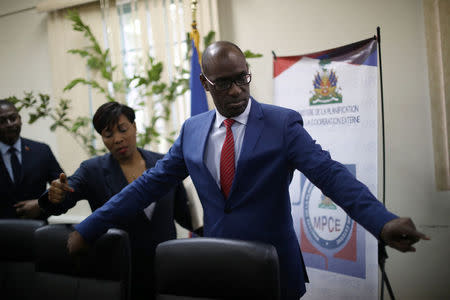 Haiti's Minister of Planning and External Cooperation Aviol Fleurant gestures at his arrival to a news conference about the resolution on the Oxfam scandal in Port-au-Prince, Haiti, June 13, 2018. REUTERS/Andres Martinez Casares