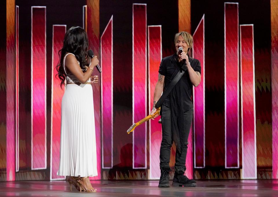 Award hosts Mickey Guyton, left, and Keith Urban shared some onstage banter after Urban performed.