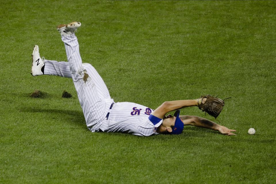 New York Mets relief pitcher Jared Hughes (35) loses control of the ball hit by Miami Marlins' Matt Joyce (7) during the eighth inning of a baseball game Friday, Aug. 7, 2020, in New York. (AP Photo/Frank Franklin II)