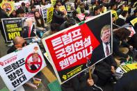 <p>South Korean protestors hold placards showing pictures of President Donald Trump during an anti-Trump rally in Seoul on Nov. 4, 2017, ahead of Trump’s visit to South Korea. (Photo: Jung Yeon-Je/AFP/Getty Images) </p>