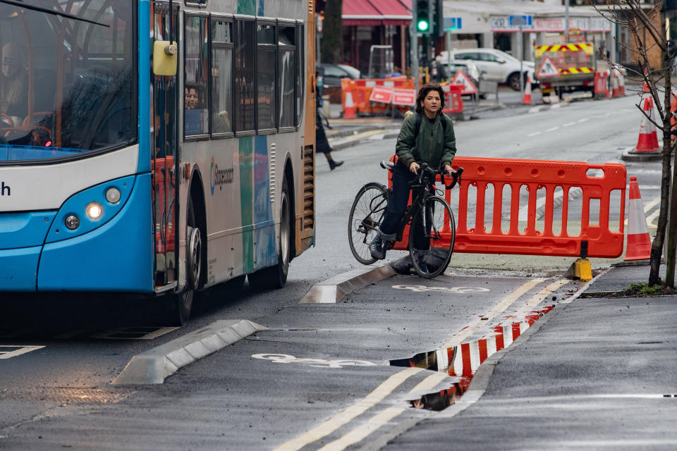 A cyclist struggles to stay in the cycle lane due to the road works. (SWNS)
