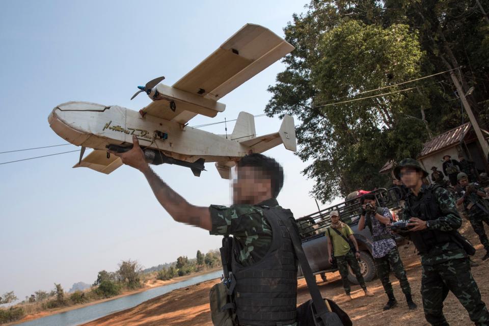 Unidentified rebel member launches a home-made drone.