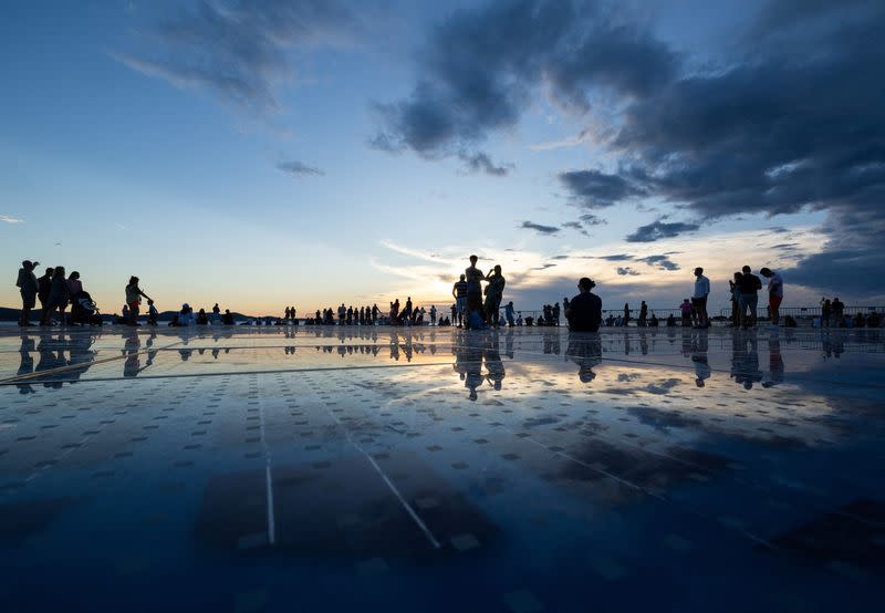 People walk during sunset, in Zadar