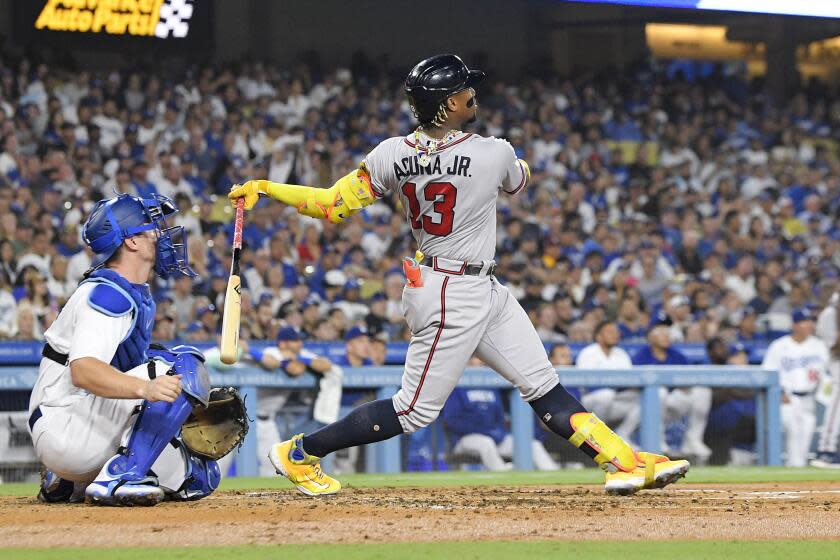 Atlanta Braves' Ronald Acuna Jr. hits a grand slam as Dodgers catcher Will Smith watches on Aug. 31, 2023, in Los Angeles.