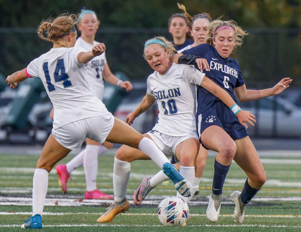 Solon's Sophie Ryan shields Hudson Ava Bell from the ball during the district final Thursday at Nordonia.