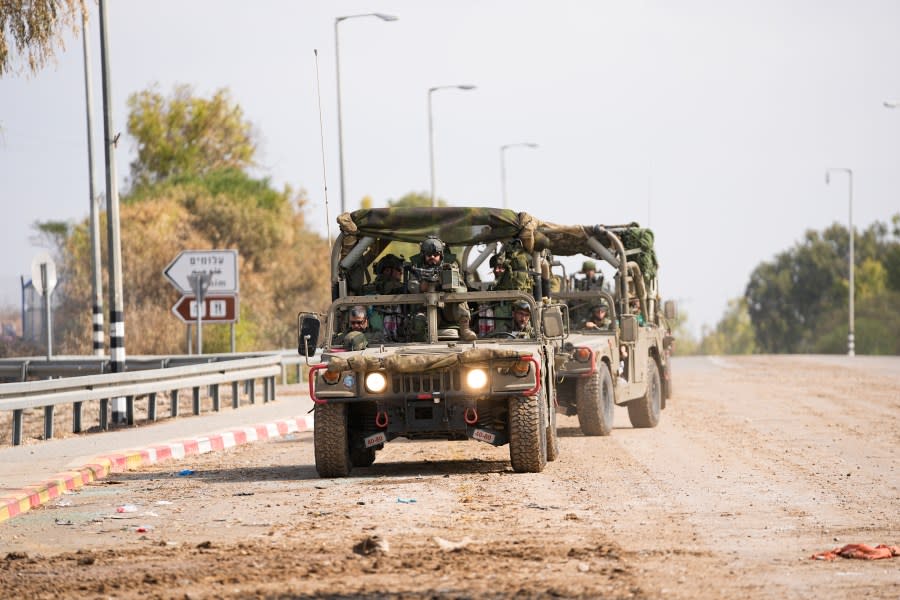 Israeli soldiers drive by the rave party site, where scores were killed, near the Kibbutz Re’im, close to the Gaza Strip border fence, on Tuesday, Oct.10, 2023. Israel’s rescue service Zaka said paramedics had recovered at least 260 bodies of people attending the party who were killed in a surprise attack by Hamas militants Saturday. (AP Photo/Ohad Zwigenberg)