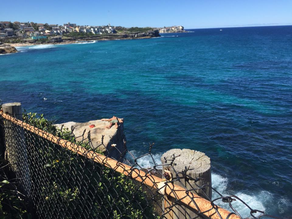 The man’s dangerous spot for sunbaking turned heads of shocked walkers on Sunday. Source: Yahoo News Australia/ Supplied