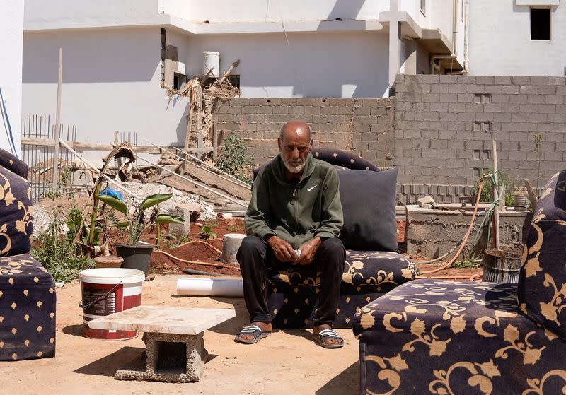 Hassan Kassar, who lost four children and a grandchild in the deadly floods last year, sits in his garden in Derna