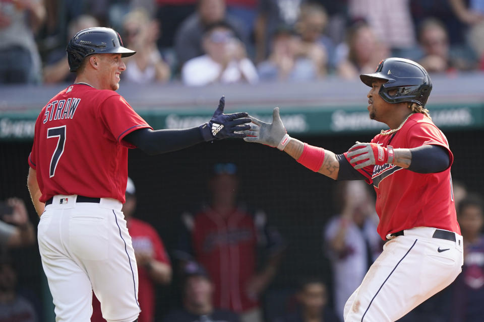 Cleveland Indians' Jose Ramirez, right, is congratulated by Myles Straw after hitting a three-run home run in the third inning of a baseball game against the Los Angeles Angels, Saturday, Aug. 21, 2021, in Cleveland. (AP Photo/Tony Dejak)