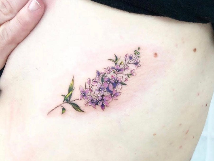 colorful Floral tattoo on ribs