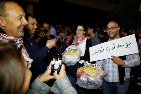 Protesters offer traditional Ramadan sweets during a protest in Amman, Jordan, June 4, 2018. Picture taken June 4, 2018. REUTERS/Muhammad Hamed