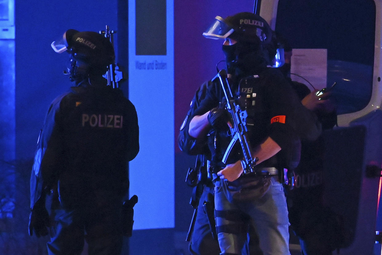 Armed police officers near the scene of a shooting in Hamburg, Germany on Thursday March 9, 2023 after one or more people opened fire in a church. The Hamburg city government says the shooting took place in the Gross Borstel district on Thursday evening. (Jonas Walzberg/dpa via AP)