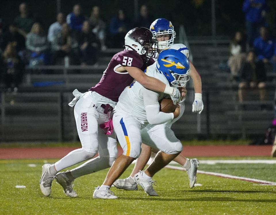 Harrison linebacker Drew Haines (58) sacks Mahopac quarterback DJ DeMatteo (15) during their 18-0 win Class A quarterfinal football action at Harrison High School in Harrison on Friday, October 27, 2023.