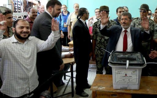 Muslim Brotherhood candidate Mohammed Mursi casts his ballot at a polling station in the city of Zagazig, 90 kms north of Cairo in the eastern part of the Nile Delta. Egyptians voted on Saturday in a run-off presidential election pitting an Islamist against Hosni Mubarak's last premier as the military rulers entered a showdown with the Islamists by disbanding parliament