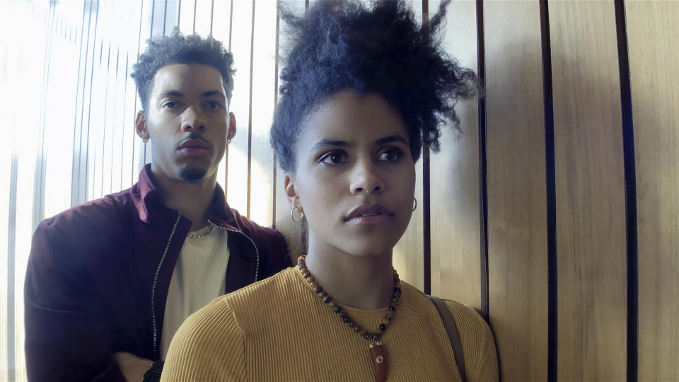 This image released by Netflix shows Melvin Gregg, left, and Zazie Beetz in a scene from "High Flying Bird." (Peter Andrews/Netflix via AP)