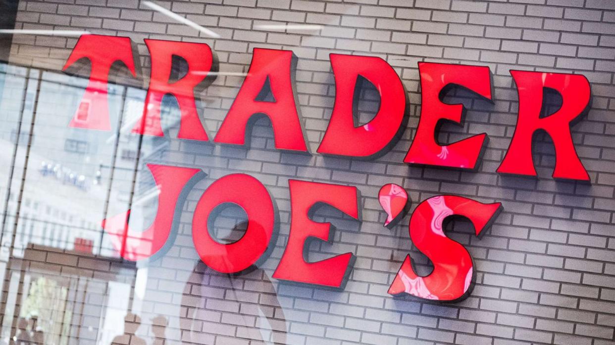 PHOTO: Shoppers are reflected in a window in front of Trader Joe's grocery store signage, July 18, 2017. (Mark Kauzlarich/Bloomberg via Getty Images)