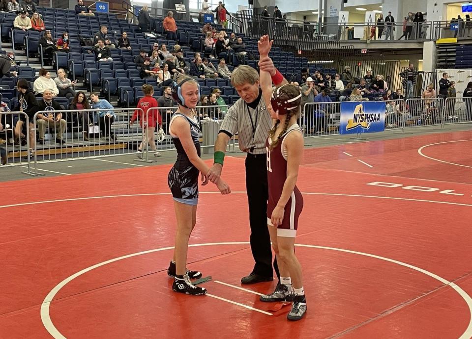 Harrison's Sienna Cozzali (right) defeated Midlakes' Abby Hargarther (left) in the opening round of the NYSPHSAA Girls Wrestling Invitational 94-pound bracket.