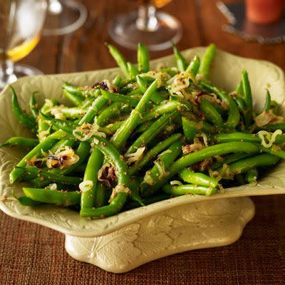 <p>Toss green beans with crispy shallots and Dijon mustard for a simple yet satisfying dish. </p><p>Get the <strong><a href="https://www.womansday.com/food-recipes/food-drinks/recipes/a22728/green-beans-shallots-thanksgiving-recipes/" rel="nofollow noopener" target="_blank" data-ylk="slk:Green Beans with Shallots recipe;elm:context_link;itc:0;sec:content-canvas" class="link ">Green Beans with Shallots recipe</a></strong>. </p>