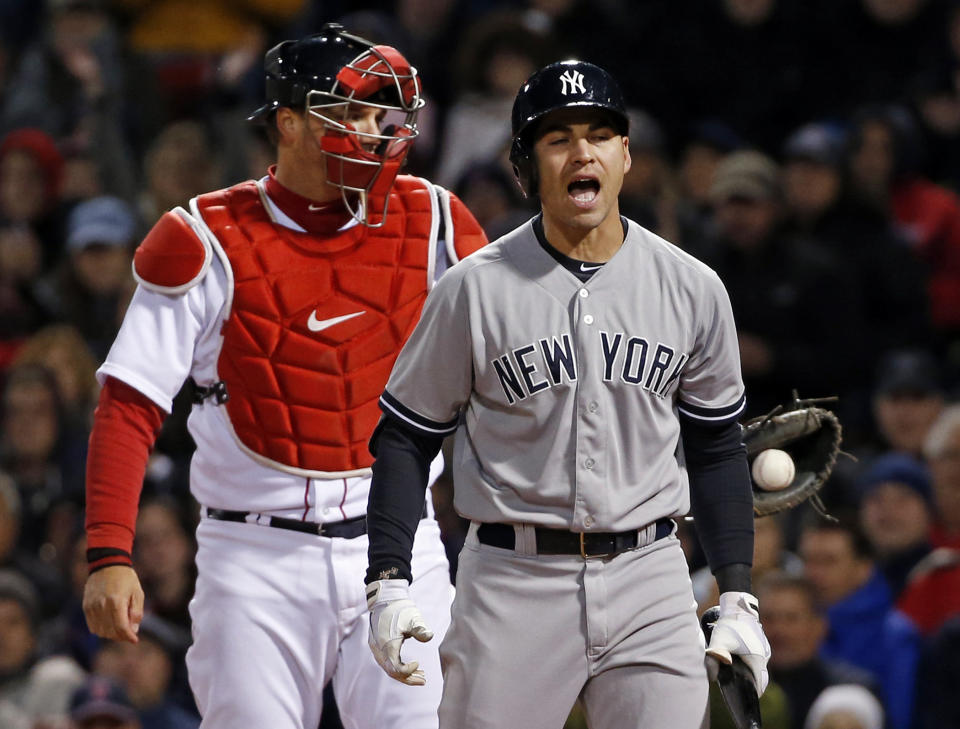 New York Yankees' Jacoby Ellsbury reacts after striking out as Boston Red Sox catcher A.J. Pierzynski holds the ball in the fifth inning of a baseball game at Fenway Park in Boston, Wednesday, April 23, 2014. (AP Photo/Elise Amendola)