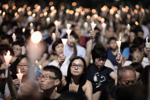 People take part in a candlelight vigil held to mark the 24th anniversary of the 1989 crackdown at Tiananmen Square, in Hong Kong, on June 4, 2013