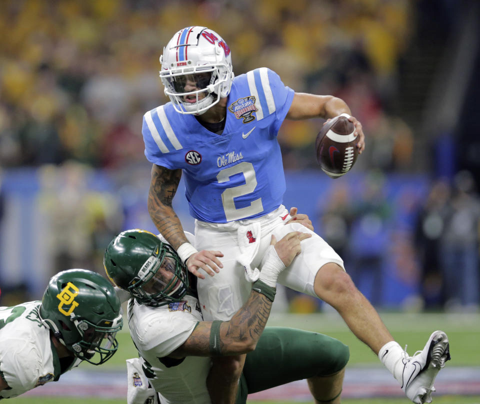 Mississippi quarterback Matt Corral (2) is tackled and injured by Baylor defensive tackle Cole Maxwell (96) during the Sugar Bowl NCAA college football game Saturday, Jan. 1, 2022 in New Orleans. (David Grunfeld/The Times-Picayune/The New Orleans Advocate via AP)