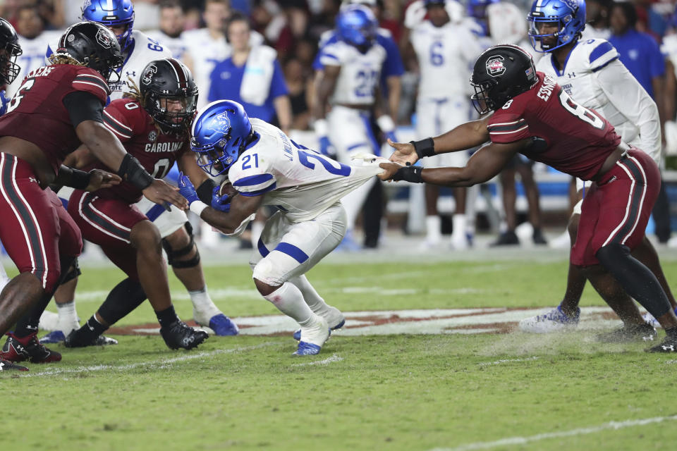 South Carolina linebacker Gilber Edmond (8) holds on to the jersey of Georgia State running back Jamyest Williams (21) during an NCAA college football game Saturday, Sept. 3, 2022, in Columbia, S.C. (AP Photo/Artie Walker Jr.)