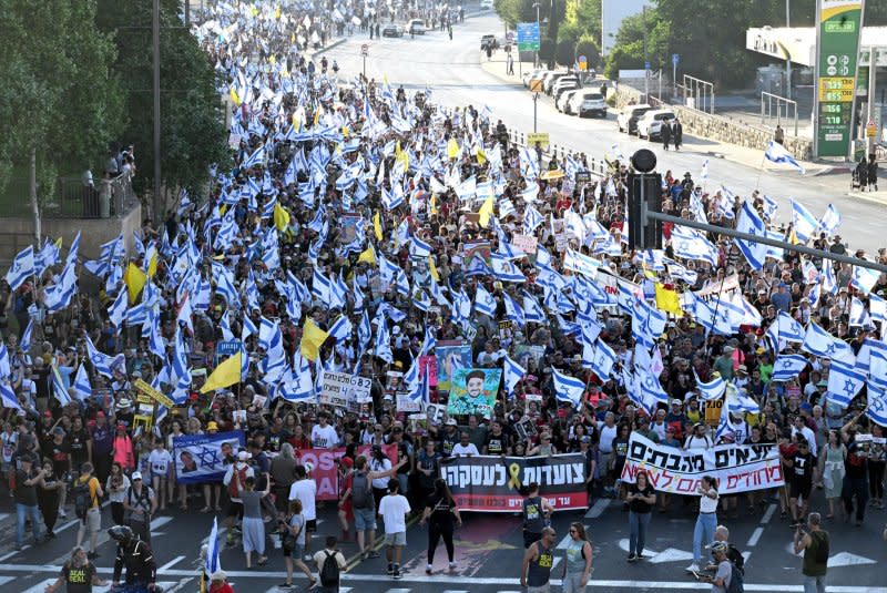 Families and supporters of Israeli hostages held captive by Hamas in Gaza carry Israeli flags and placards on July 13 as they enter Jerusalem on the final day of a four day march from Tel Aviv demanding a deal for the release of hostages. Photo by Debbie Hill/ UPI