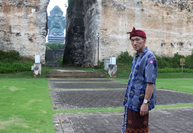 Effendy, a 65-year-old ethnic Chinese tour guide who also uses the name Lin Wen Hui, poses for pictures at Garuda Wisnu Kencana Cultural Park in South Kuta, following coronavirus disease (COVID-19) outbreak, Bali